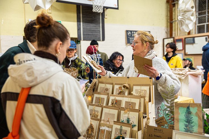 people buying Xmas cards at the market stall