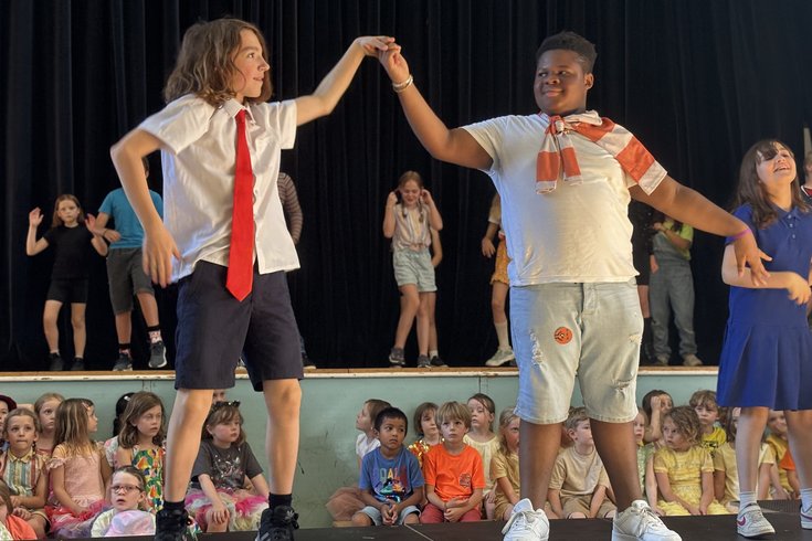 Two students dancing in a show.