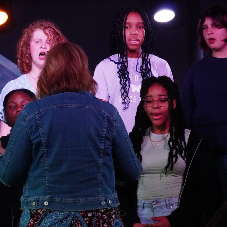 Young vocalists sing on stage as part of Live Voices Choir