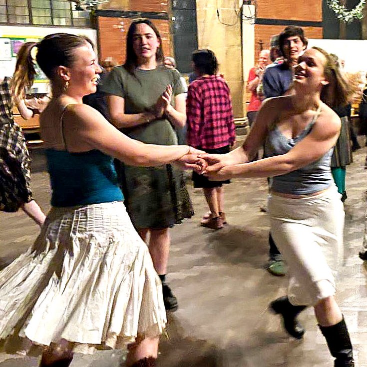 A room full of people dancing from a previous Box of Delights Ceilidh Band event.