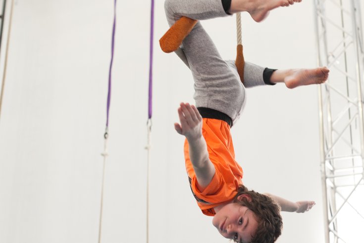 Boy on a static trapeze