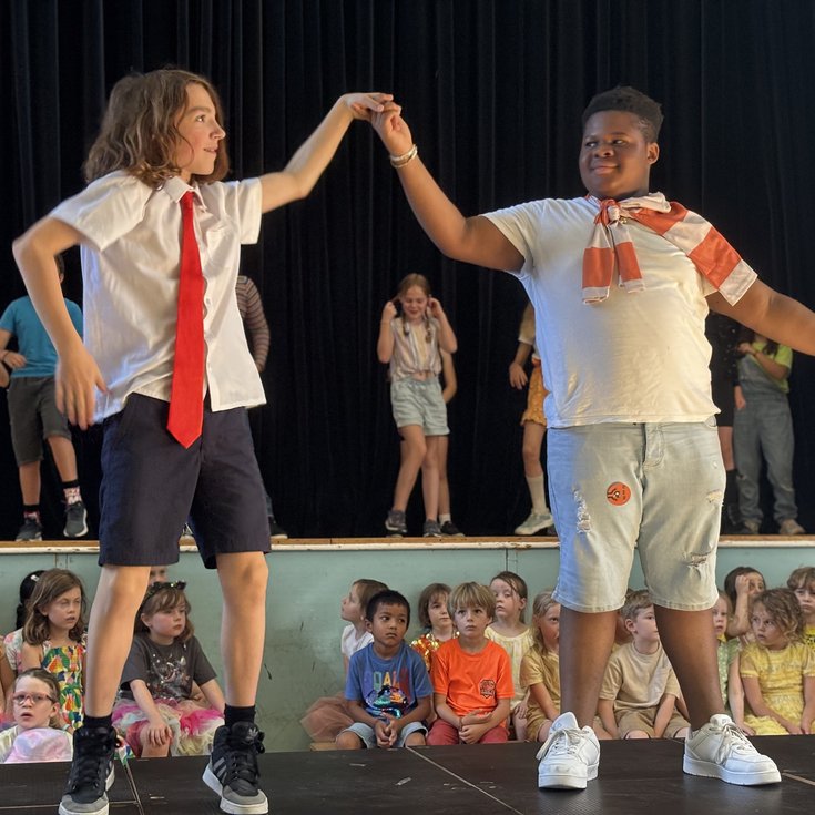 Two students dancing in a show.