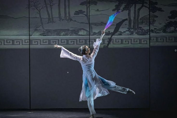 Costumed dancer performing Chinese Fan Dance