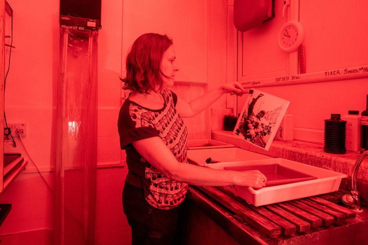Person developing images in a dark room