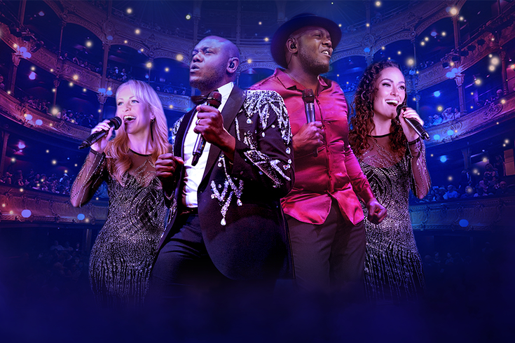 Four singers passionately perform on stage, holding microphones. The setting is a grand theatre with glowing lights and an audience. The mood is vibrant and dynamic.