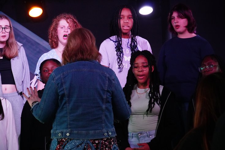 Young vocalists sing on stage as part of Live Voices Choir