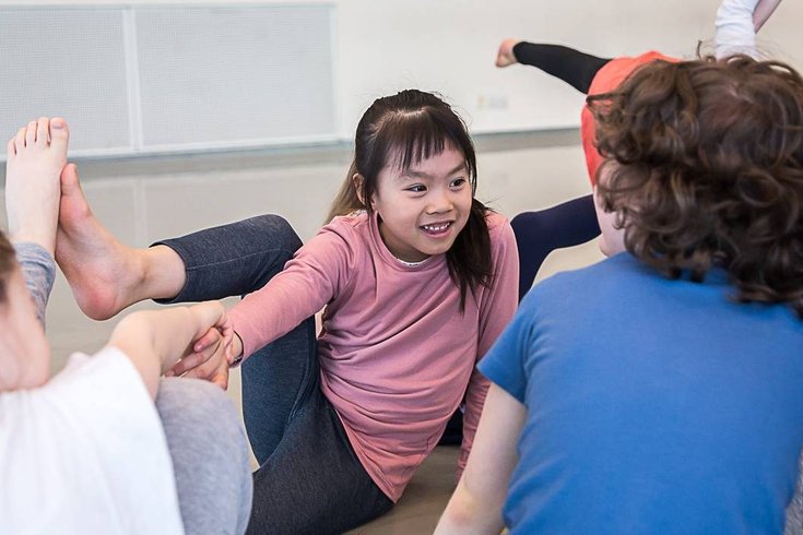 A group of young children dancing.