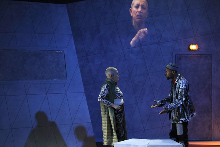 Quiet Rebels. Tour 2022. Written and directed by Hassan Mahamdallie and Julie McNamara. Photo featuring Fiona Whitelaw (on the left), Joe Conteh (on the right) and Clare Edwards (video projection).