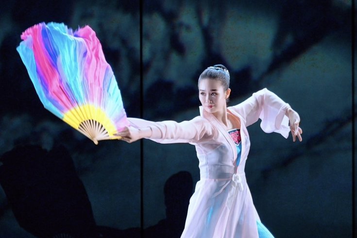 Costumed dancer performing Chinese Fan Dance