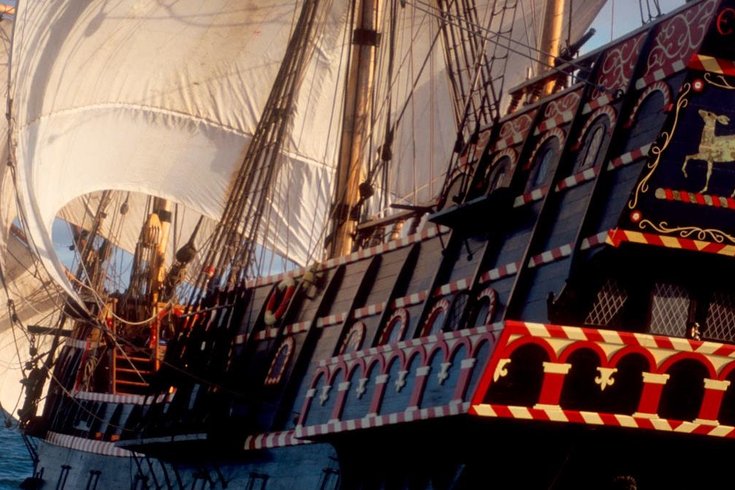Promotional image of The Golden Hinde, the famous ship, out at sea with the wind in her sails.