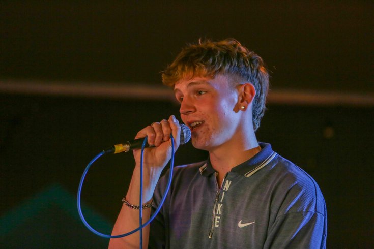 A young person raps into the mic