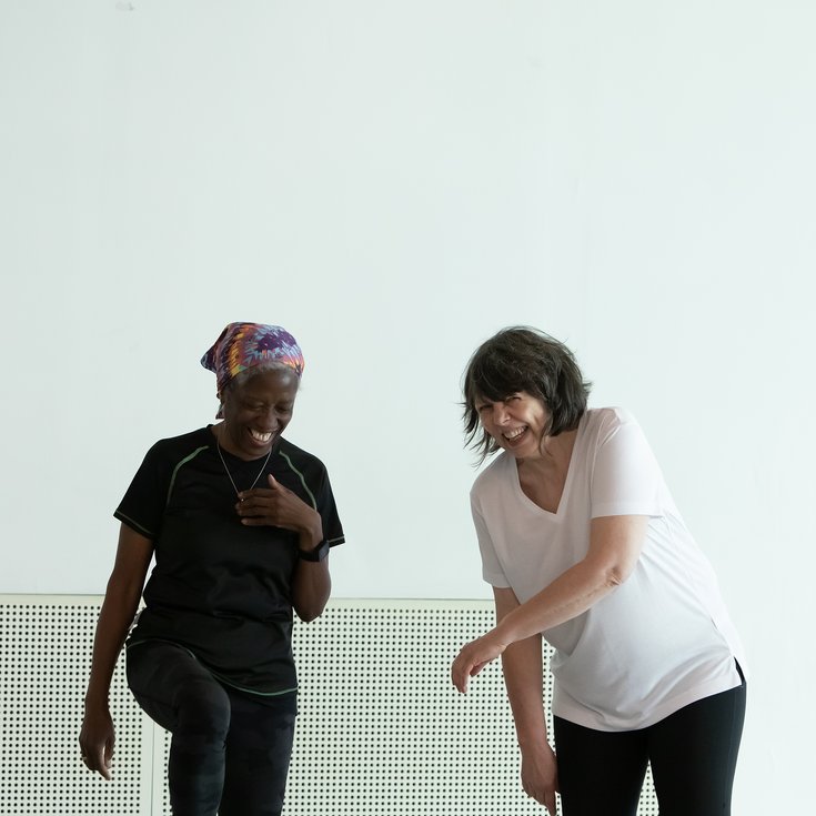 Two people dancing together in a studio