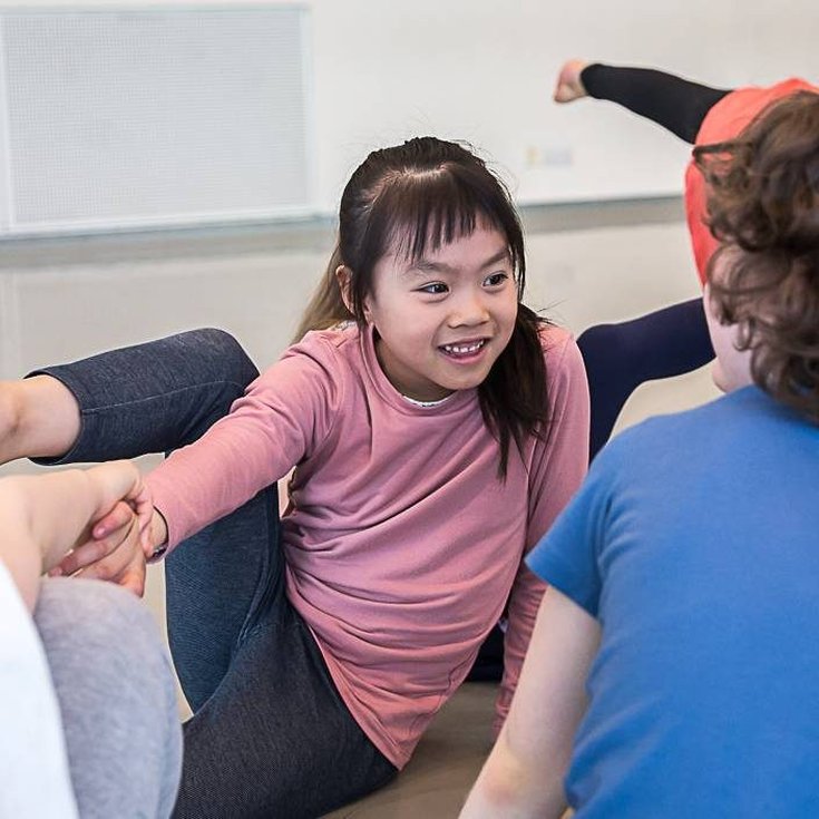 A group of young children dancing.