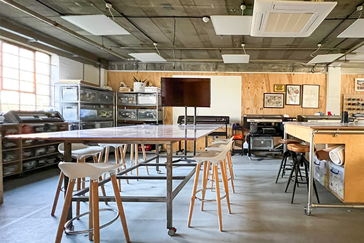 Materialise Workshop Space at Blue Garage - big windows, stools, and a chipboard wall in a maker space