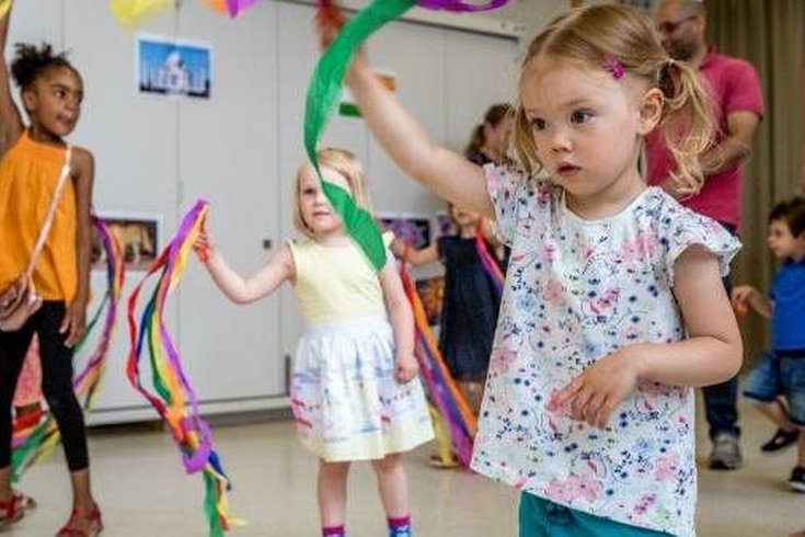 A group of young children dancing.