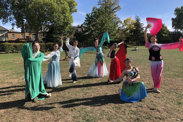 7 Costumed dancers posing in the style of various Chinese Dances