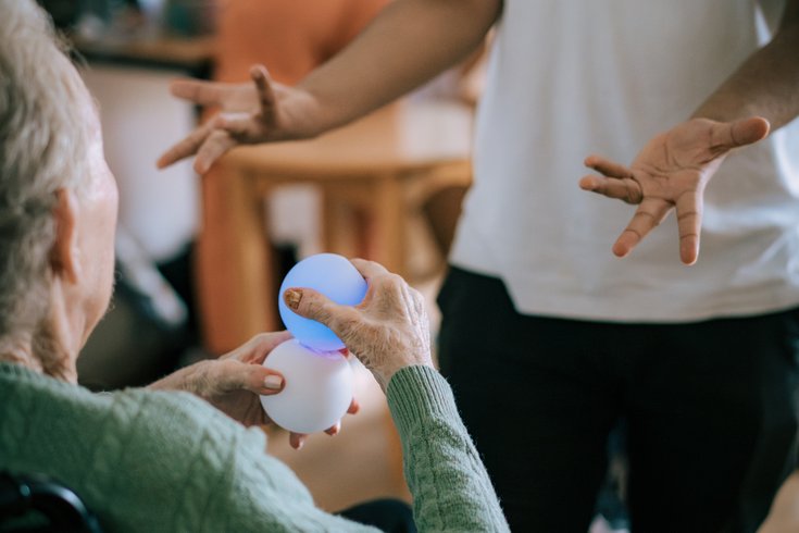 Spare Tyre facilitator, Sabir, interacting with a care home resident at Acacia Care Centre, 2024. Photo by Yijia Fu