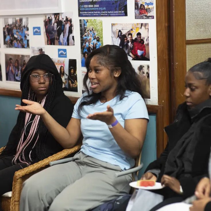 Young woman leading community discussion event