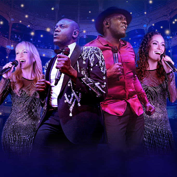 Four singers passionately perform on stage, holding microphones. The setting is a grand theatre with glowing lights and an audience. The mood is vibrant and dynamic.