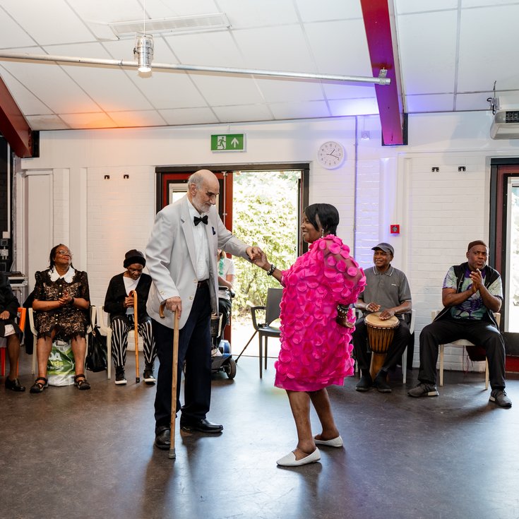 Two members dancing in the centre of a circle of onlookers. Credit Elena Ledgister.