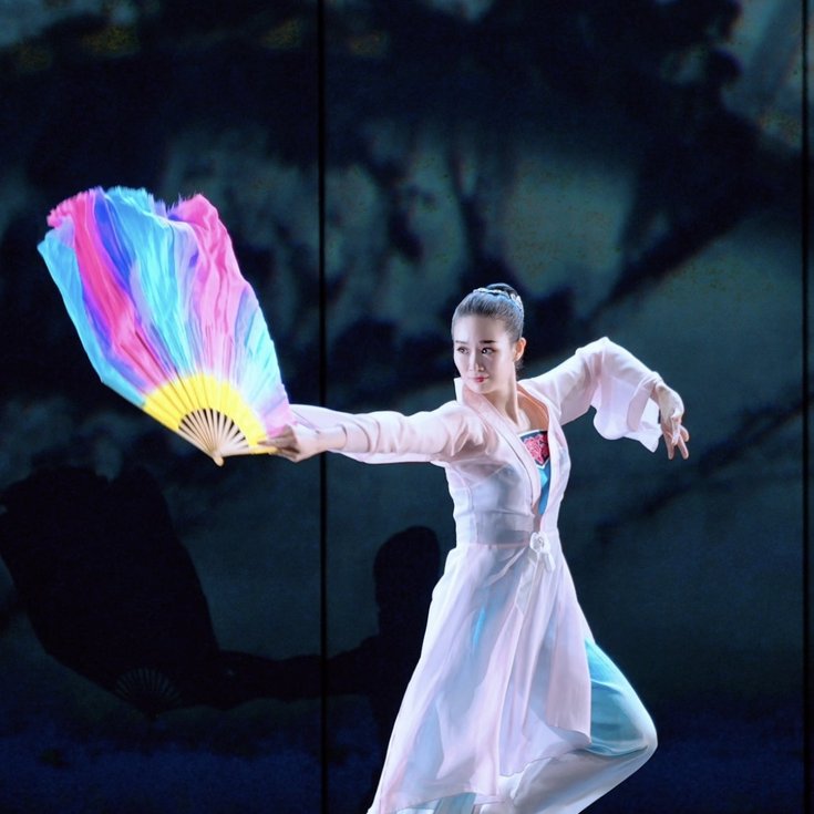 Costumed dancer performing Chinese Fan Dance