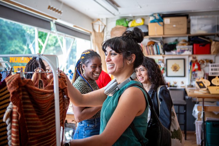 Visitors smiling while browsing textiles at Cockpit Open Studios
