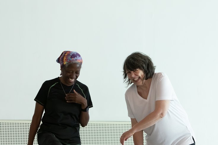Two people dancing together in a studio