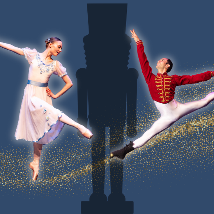 Two ballet dancers female and male dancing in front of a silhouette of a Nutcracker