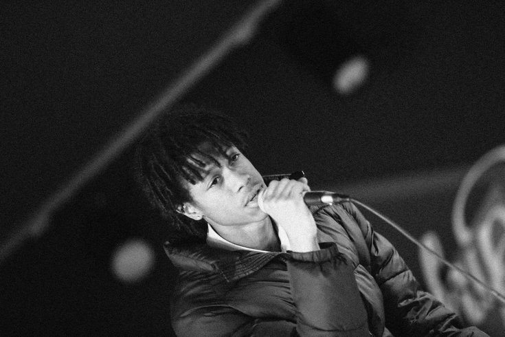 A young person raps into the mic