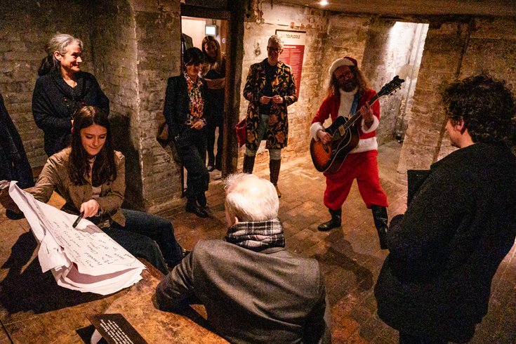 Santa writing a song with the audience