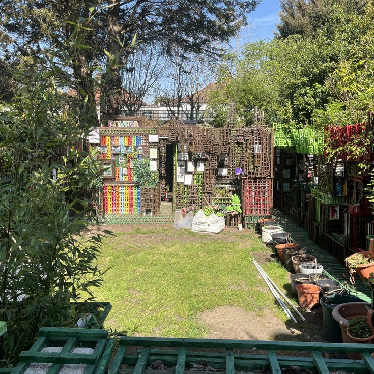 Image from a distance pf Povera Shed and the garden