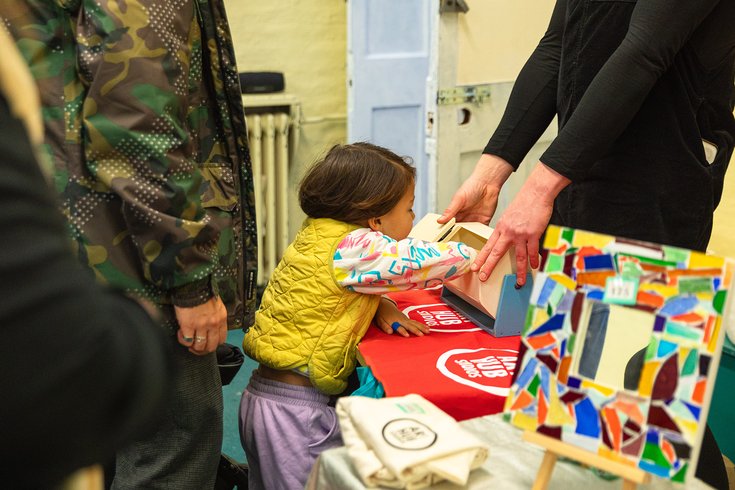 A small child playing the raffle