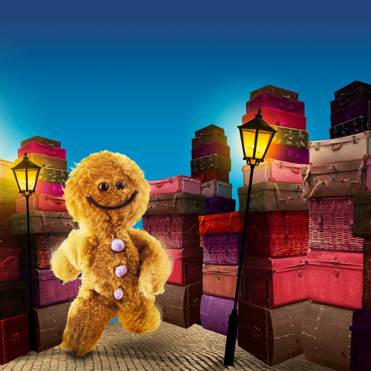 A fluffy gingerbread man in front of a pile of colourful boxes and street lamps