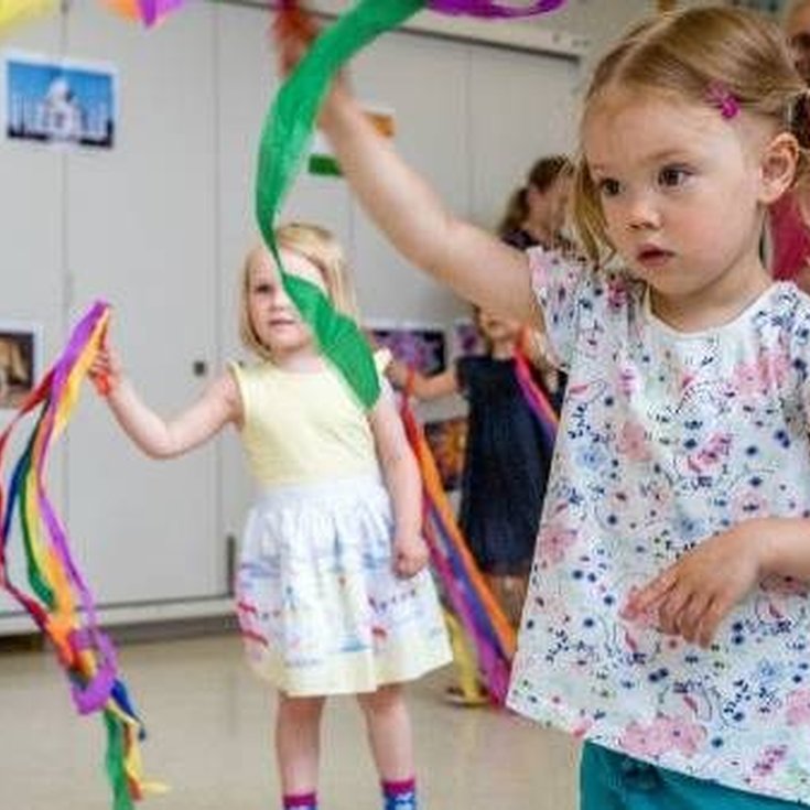 A group of young children dancing.