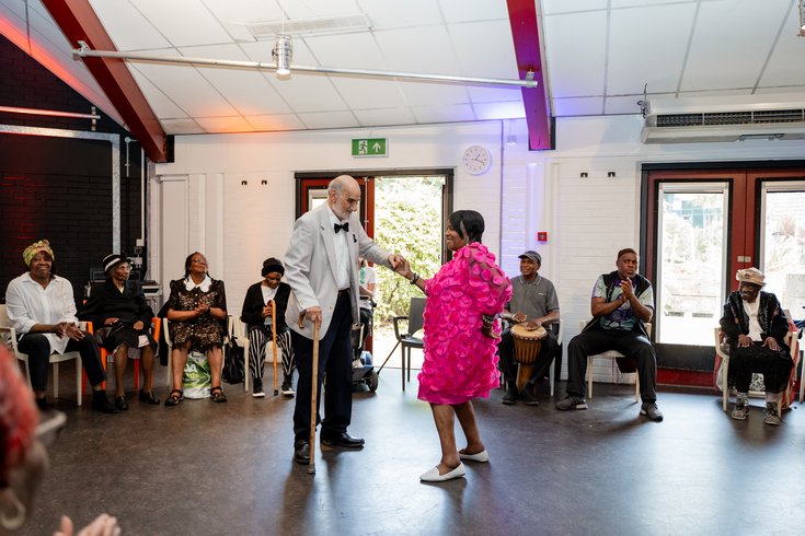 Two members dancing in the centre of a circle of onlookers. Credit Elena Ledgister.