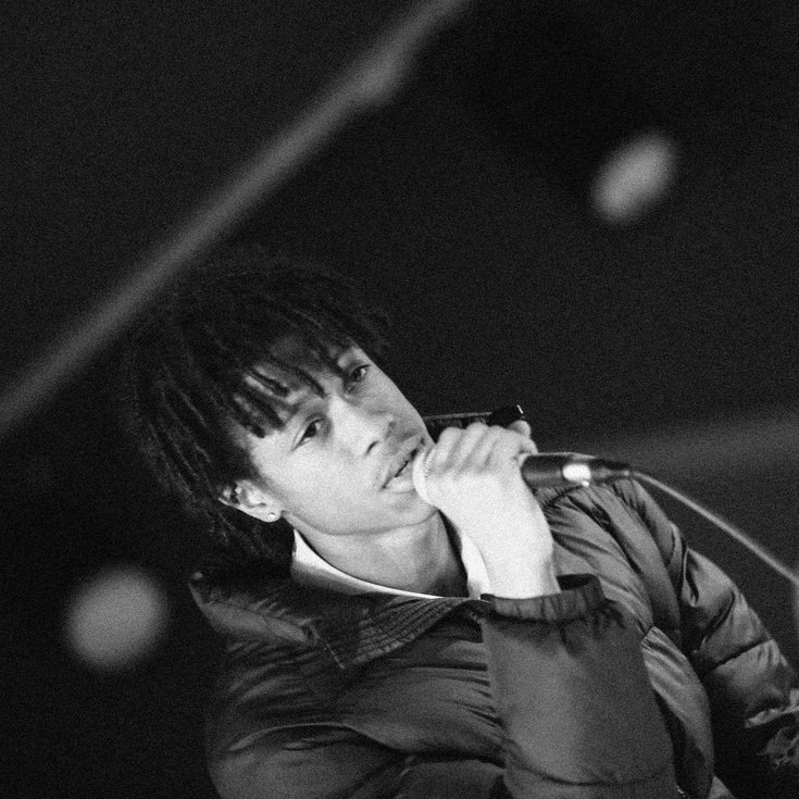 A young person raps into the mic