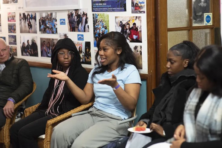 Young woman leading community discussion event