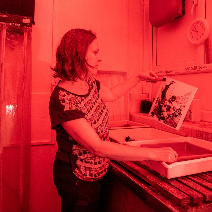 Person developing images in a dark room