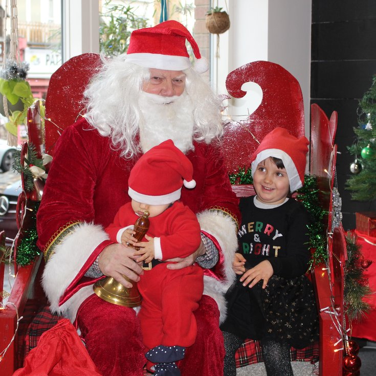 Santa in his sleigh with two children