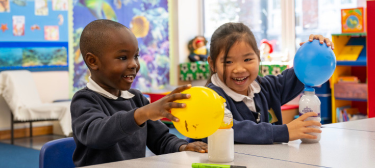 Two school children doing a craft activity